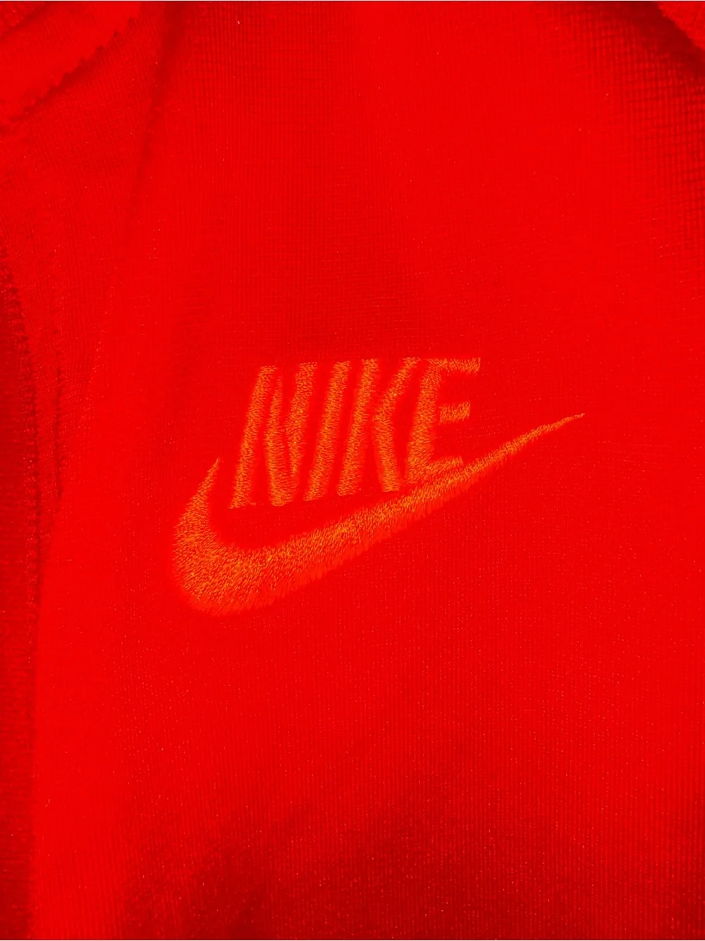 Nike Red Track Jacket with Navy Shoulder Panels and orange Logo